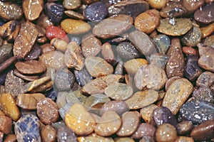 Water Falls on pebbles stone close up