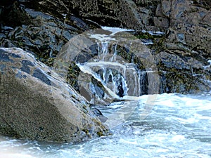 Water falls from wave splashed rocks