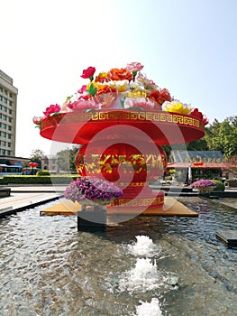 Water feature decorated day bright red flowers and vase outdoors