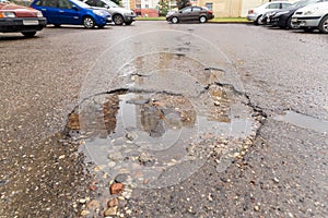 Water filled pot hole in the road