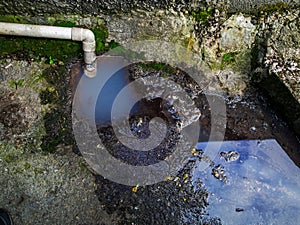 Water flow from a block drain pipe onto a ground, Ecology and environment protection concept