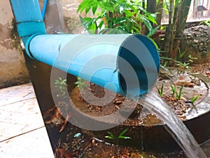 Water Flow from a Blue Pipe