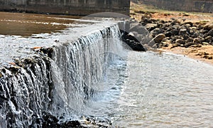 water flow out of the reservoir gate and from mini waterfall