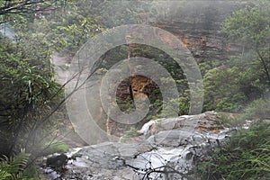 Water flow over the ledge at misty Wentworth Falls photo