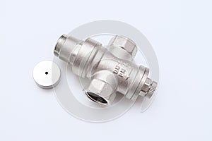 Water flow regulator, pressure reducer valve with a removed cup on white background, new repair part for plumbing, water