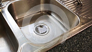 Water flowing down the drain in kitchen sink