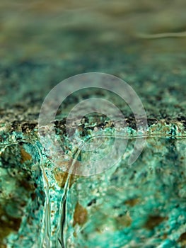 Water flowing down a turquoise blue ledge