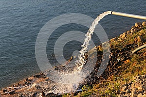 Water flowing from a drainage pipe into the river