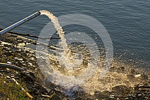 Water flowing from a drainage pipe into the river