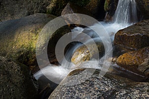 Water flowing and falling off large rocks