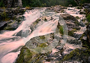 Water flowing fast in small waterfall