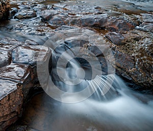 Water flowing over basalt rocks ,river pleches ,lozere France. close up photo