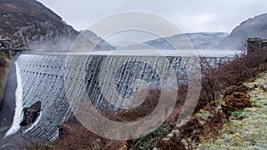 Caban Coch dam with mist rising photo