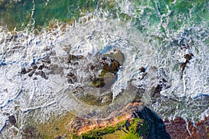 Water flowing over coastal rocks and eroded rock chasms