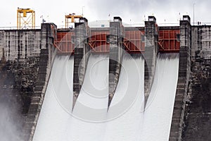 Water flowing over floodgates of a dam at Khun Dan Prakan Chon, Nakhon Nayok Province, Thailand