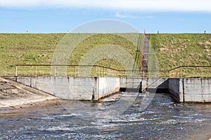 Water flowing over floodgates photo