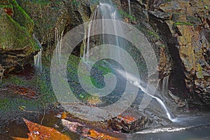 Water flowing over moss covered rocks