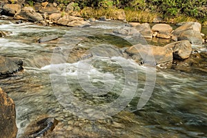 Water flowing over rapid with rocks and boulders