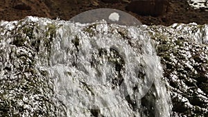 Water flowing over a rock