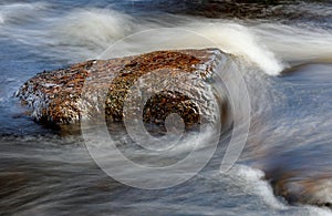 Water flowing over rocks in rapids