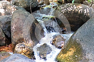 water flowing over rocks and waterfall