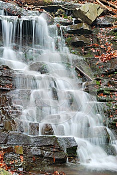 Water flowing over rocks in waterfall cascade