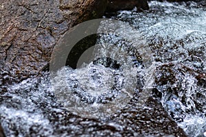 water flowing over rocks and waterfall