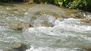 Water flowing into the river mountain in summer 4k video