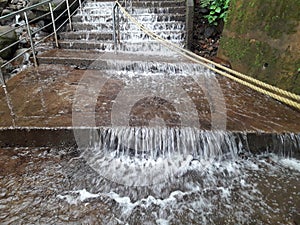 Water flowing in speed on stairs at Amboli waterfall India