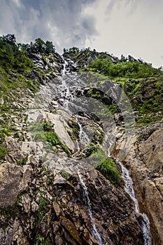 Water flowing from the tops of rocks.