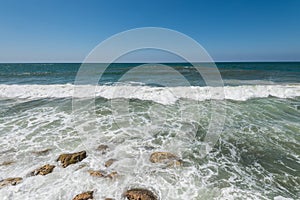 Water flowing and waves on the stone in the mediterranean sea at the Tel Aviv port, Israel
