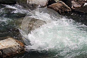 Water flowing white with foam in a mountain creek