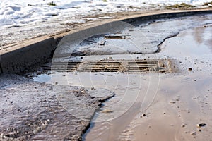 Water flows along road to sewer grate