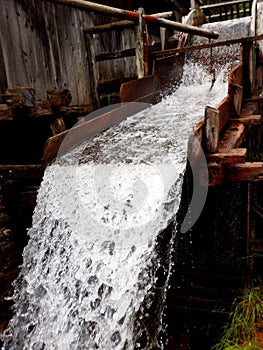 Water flows channeled into an wooden old mill