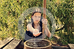 Water flows from the girl's hands toned