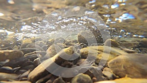 Water flows in mountain river. Shooting inside water flow.