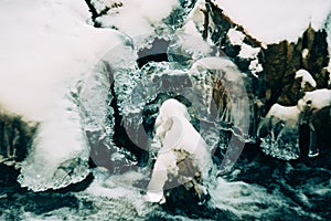 Water flows over a partially frozen Upper Cataract Falls in rural Indiana.