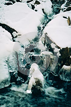 Water flows over a partially frozen Upper Cataract Falls in rural Indiana.