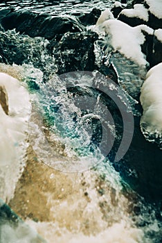 Water flows over a partially frozen Upper Cataract Falls in rural Indiana.