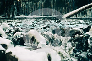 Water flows over a partially frozen Upper Cataract Falls in rural Indiana.