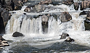 Water flows over the rocks within the Potomac River at Great Falls, Virginia photo