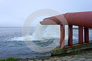 Water flows from a pipe. Water flows from a pipe into a large lake