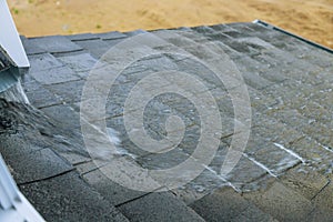 Water flows on the roof during a heavy downpour