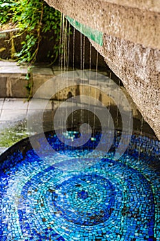 Water fontain with blue mosaic