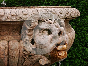 Water fountain with grotesque, carved face