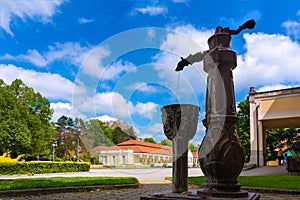 Water fountain and historical building on spa island in Piestany