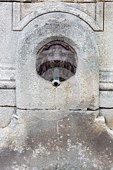 Water fountain, lion head made of bronze photo