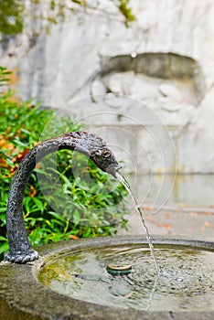 Water fountain near memorial of dying lion in Lucerne, Switzerland