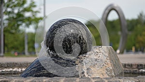 A water fountain with a spinning ball. a statue of a ball in a fountain.