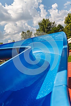 Water fun in the pool, slide. Concept, cheerful, perky bright colorful summer and relaxation. View from above